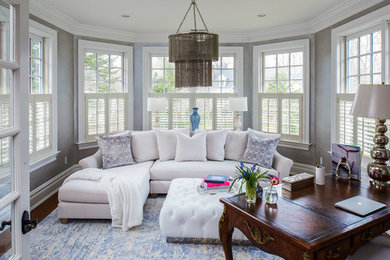Transitional dark wood floor living room photo in New York with gray walls