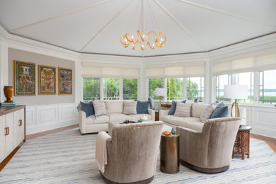 Inspiration for a coastal medium tone wood floor, brown floor and vaulted ceiling living room remodel in New York with white walls
