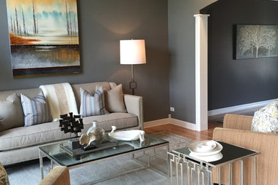 Large elegant open concept light wood floor living room photo in Chicago with gray walls and no tv