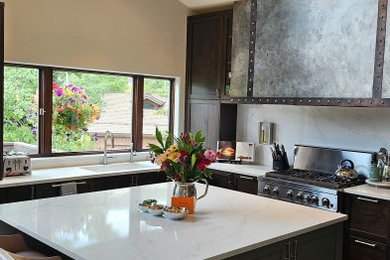 Kitchen pantry - mid-sized transitional l-shaped medium tone wood floor, brown floor and vaulted ceiling kitchen pantry idea in Denver with an undermount sink, shaker cabinets, dark wood cabinets, quartz countertops, white backsplash, quartz backsplash, paneled appliances, an island and white countertops