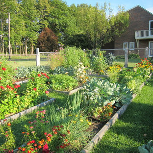 Traditional garden in Burlington with with raised garden bed.