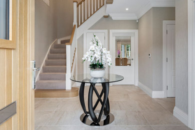Design ideas for a large transitional hallway in Berkshire with beige walls, ceramic floors, beige floor and wallpaper.