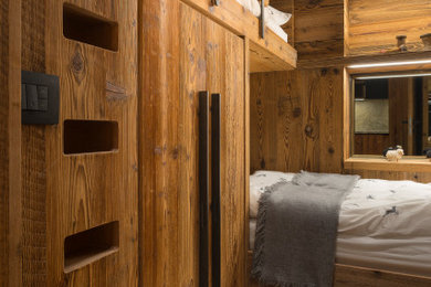 Design ideas for a country kids' bedroom in Other with brown walls, medium hardwood floors, brown floor and wood walls.