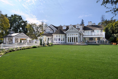 Inspiration for a large timeless gray two-story wood house exterior remodel in Los Angeles with a shingle roof
