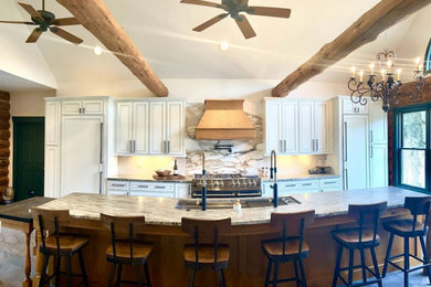 Example of a kitchen design in Other with shaker cabinets, white cabinets, granite countertops, stone slab backsplash and an island