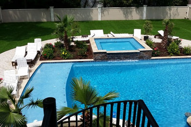 Example of a mid-sized classic backyard custom-shaped hot tub design in Charlotte