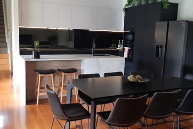 Inspiration for a modern kitchen in Melbourne with marble benchtops.