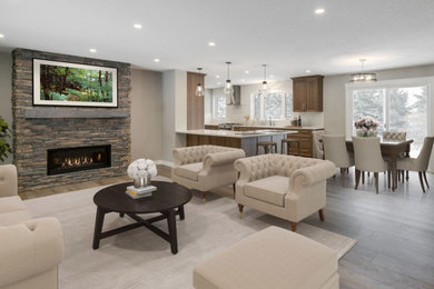 Living room - large traditional formal and open concept vinyl floor and brown floor living room idea in Calgary with gray walls, a standard fireplace, a stacked stone fireplace and no tv