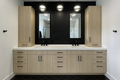 Large trendy master ceramic tile, black floor and double-sink bathroom photo in Tampa with flat-panel cabinets, light wood cabinets, black walls, quartz countertops, white countertops and a built-in vanity