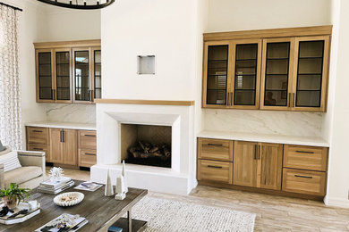 Living room - mid-sized transitional formal and open concept porcelain tile and brown floor living room idea in Phoenix with white walls, a standard fireplace, a plaster fireplace and a wall-mounted tv