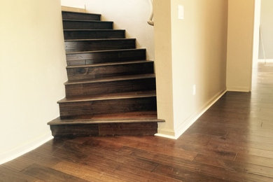 This is an example of a small traditional wood curved staircase in Los Angeles with wood risers.