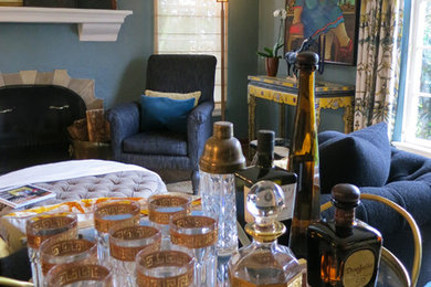 Eclectic light wood floor living room photo in Seattle with blue walls, a bar, a standard fireplace and a plaster fireplace