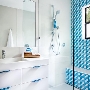 spunky, contemporary bathroom featuring clé cement tile shower wall