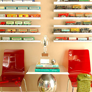 Inspiration for a small contemporary home office in Orange County with travertine floors and beige walls.