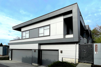 Contemporary gray two-story concrete fiberboard exterior home idea in Seattle with a white roof