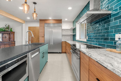 Inspiration for a mid-sized 1960s galley porcelain tile and gray floor enclosed kitchen remodel in Seattle with a single-bowl sink, flat-panel cabinets, medium tone wood cabinets, granite countertops, stainless steel appliances and an island