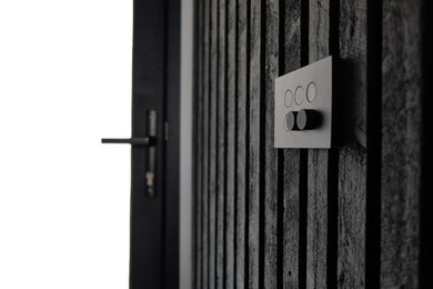 This is an example of a contemporary hallway in Geelong with black walls and wood walls.