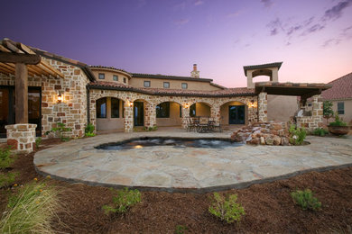 Inspiration for a large transitional beige mixed siding house exterior remodel in Austin