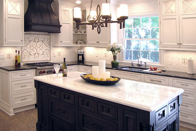 Eat-in kitchen - mid-sized traditional l-shaped porcelain tile and brown floor eat-in kitchen idea in New York with an undermount sink, recessed-panel cabinets, white cabinets, marble countertops, white backsplash, mosaic tile backsplash and an island