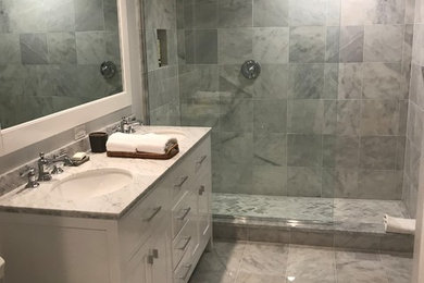 Inspiration for a large modern master gray tile and stone tile marble floor, gray floor and double-sink bathroom remodel in New York with shaker cabinets, white cabinets, a two-piece toilet, gray walls, an undermount sink, quartz countertops, gray countertops and a freestanding vanity