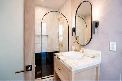 Bathroom - modern kids' pink tile and porcelain tile laminate floor, brown floor and single-sink bathroom idea in New York with shaker cabinets, brown cabinets, a one-piece toilet, pink walls, a vessel sink, quartzite countertops, a niche and a freestanding vanity