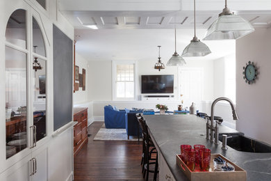 Example of a large transitional dark wood floor and brown floor eat-in kitchen design in Philadelphia with an integrated sink, recessed-panel cabinets, white cabinets, soapstone countertops, stainless steel appliances and an island