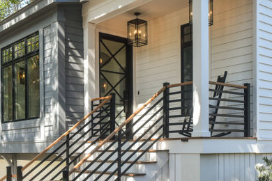 This is an example of a coastal porch design in Charleston.