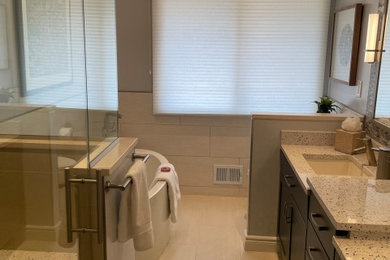 Example of a mid-sized transitional kids' multicolored tile and porcelain tile porcelain tile, beige floor and double-sink bathroom design in DC Metro with shaker cabinets, blue cabinets, a one-piece toilet, gray walls, an undermount sink, recycled glass countertops, a hinged shower door, multicolored countertops and a built-in vanity