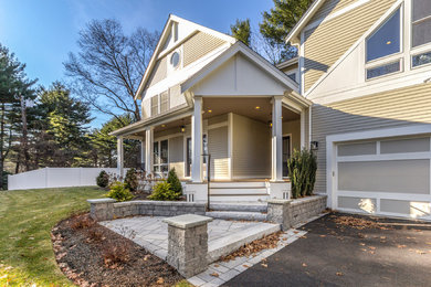 Example of a large transitional beige two-story mixed siding exterior home design in Boston with a shingle roof