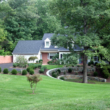 Manicured Landscape with Fieldstone Retaining Walls and Evergreens