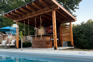 Example of a mid-sized minimalist backyard concrete patio design in Indianapolis with a gazebo