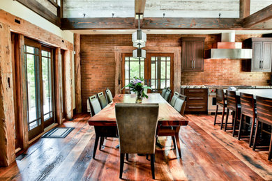 Kitchen/dining room combo - mid-sized farmhouse medium tone wood floor and brown floor kitchen/dining room combo idea in Other