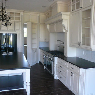 Large traditional kitchen pantry photos - Kitchen pantry - large traditional u-shaped porcelain floor kitchen pantry idea in Orlando with a single-bowl sink, raised-panel cabinets, white cabinets, granite countertops, white backsplash, subway tile backsplash, stainless steel appliances and an island