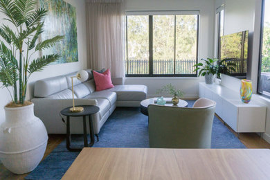 Design ideas for a small contemporary open concept living room in Brisbane with light hardwood floors.