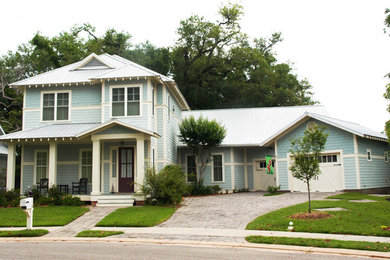 Photo of a large traditional two-storey blue exterior in New Orleans with mixed siding and a hip roof.