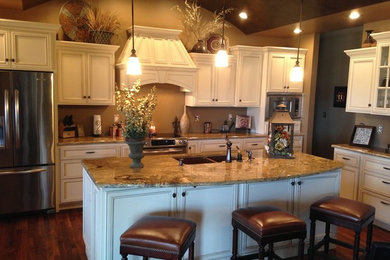 Large transitional l-shaped medium tone wood floor and brown floor eat-in kitchen photo in Other with an undermount sink, recessed-panel cabinets, yellow cabinets, laminate countertops, stainless steel appliances and two islands
