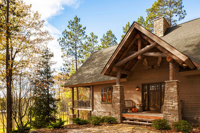 Inspiration for a large rustic beige one-story wood exterior home remodel in Detroit with a hip roof