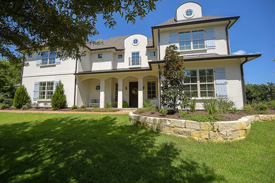 Example of a large arts and crafts beige two-story stucco exterior home design in Austin