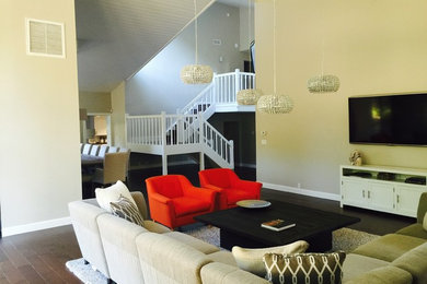 Example of a mid-sized minimalist open concept medium tone wood floor living room design in Los Angeles with beige walls, no fireplace and a wall-mounted tv