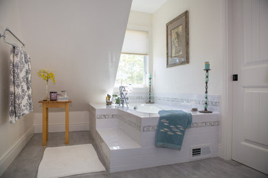 Mid-sized trendy master white tile and subway tile porcelain tile and gray floor corner shower photo in Denver with furniture-like cabinets, white cabinets, an undermount tub, beige walls, an undermount sink and marble countertops