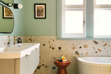 Example of a mid-sized danish kids' multicolored tile and porcelain tile porcelain tile, multicolored floor and double-sink bathroom design in Other with gray cabinets, a wall-mount toilet, blue walls, an integrated sink, solid surface countertops, white countertops and a floating vanity