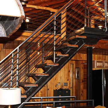 Steel floating stair case wrapped with Reclaimed wood