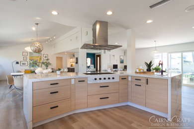 This is an example of a large modern l-shaped kitchen/diner in San Diego with a submerged sink, flat-panel cabinets, white cabinets, engineered stone countertops, white splashback, ceramic splashback, stainless steel appliances, vinyl flooring, an island, brown floors and white worktops.