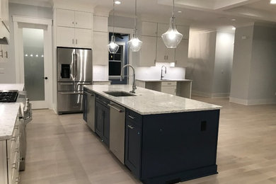 Example of a mid-sized transitional l-shaped light wood floor and beige floor open concept kitchen design in Cincinnati with an undermount sink, shaker cabinets, white cabinets, granite countertops, stainless steel appliances, an island and gray countertops