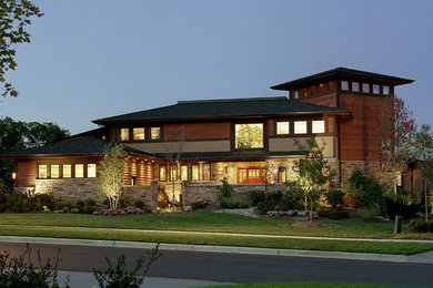 Inspiration for a large contemporary multicolored two-story mixed siding house exterior remodel in Cleveland with a hip roof and a shingle roof
