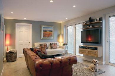 Large contemporary grey and brown enclosed living room in Hertfordshire with grey walls, ceramic flooring, a wall mounted tv and brown floors.