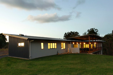 This is an example of a mid-sized modern one-storey exterior in Brisbane.
