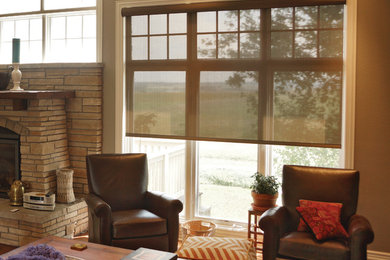 Inspiration for a mid-sized transitional open concept dark wood floor and brown floor living room remodel in Denver with beige walls, a standard fireplace, a stone fireplace and no tv