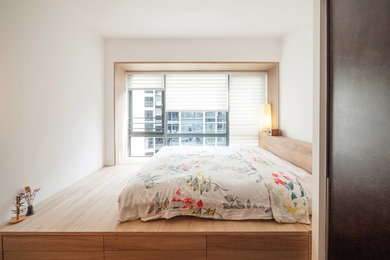 Inspiration for a mid-sized scandinavian master dark wood floor and brown floor bedroom remodel in Singapore with white walls