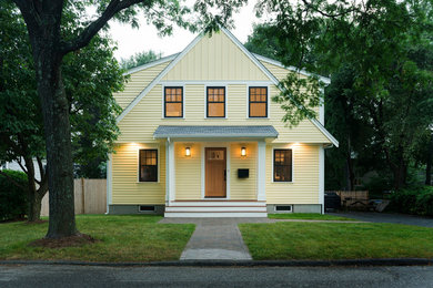 Example of a mid-sized transitional yellow two-story vinyl exterior home design in Boston